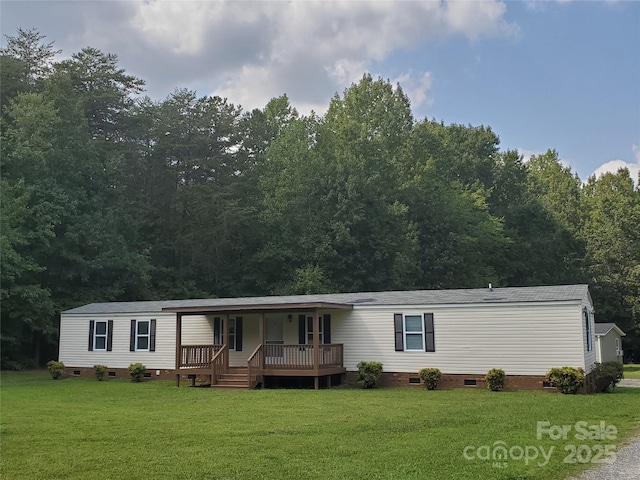 manufactured / mobile home featuring crawl space, a porch, and a front yard