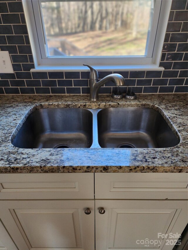 624 Brevard St, Kings Mountain, NC 28086 - kitchen view of a sink, tasteful backsplash, and light stone countertops