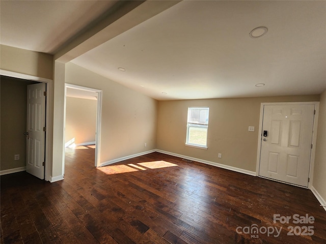 unfurnished room featuring dark wood-style flooring, baseboards, recessed lighting, and lofted ceiling