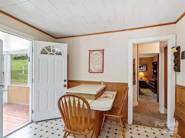 43 Charter Way, Burnsville, NC 28714 - dining room featuring light flooring, wooden walls, wainscoting, and ornamental molding