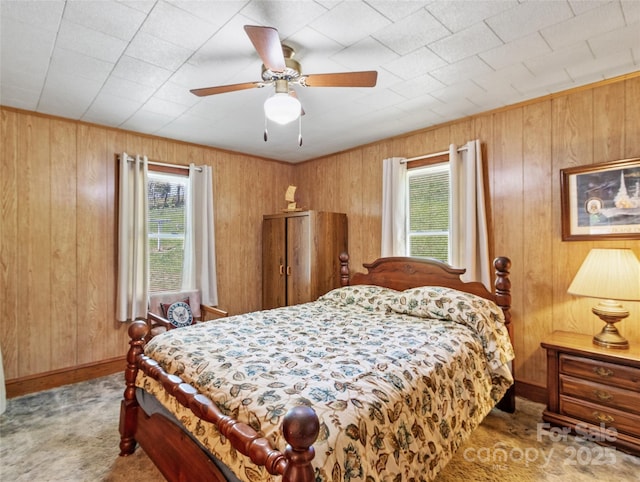 43 Charter Way, Burnsville, NC 28714 - carpeted bedroom featuring multiple windows, wooden walls, baseboards, and ceiling fan