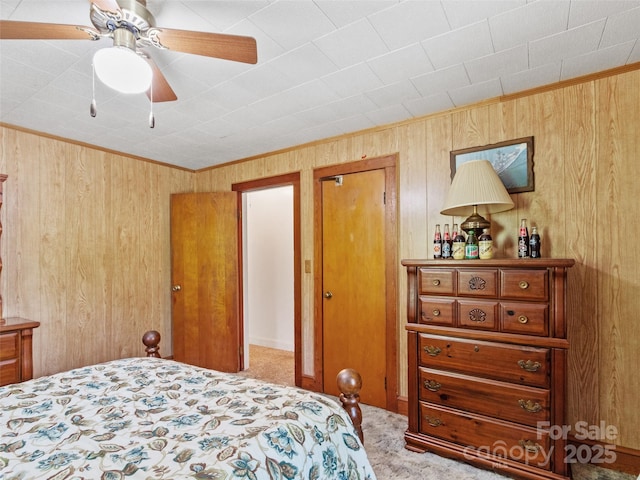 43 Charter Way, Burnsville, NC 28714 - carpeted bedroom with wood walls, a ceiling fan, and ornamental molding