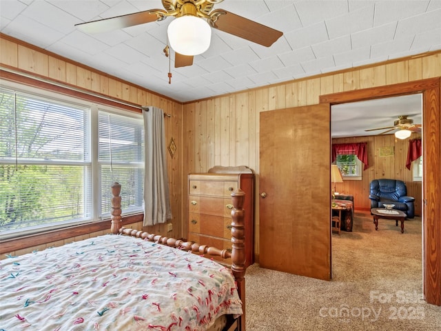 43 Charter Way, Burnsville, NC 28714 - carpeted bedroom featuring wood walls and ceiling fan