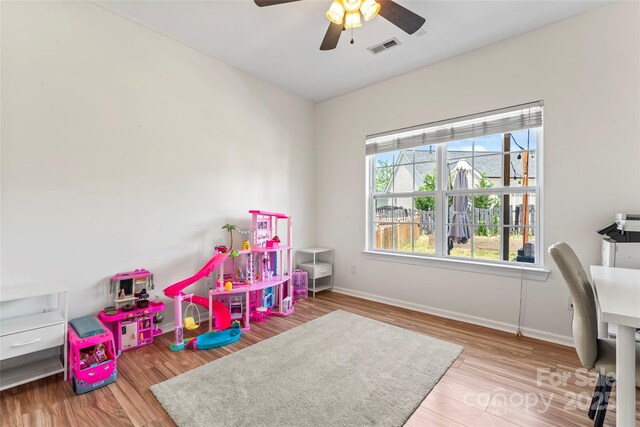game room with ceiling fan, baseboards, and wood finished floors