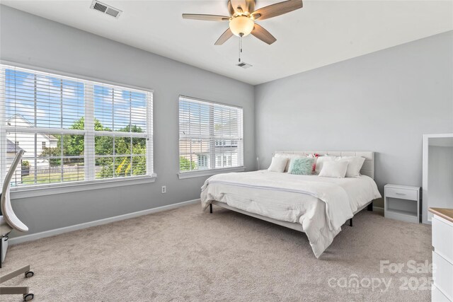 bedroom featuring carpet floors, baseboards, and ceiling fan