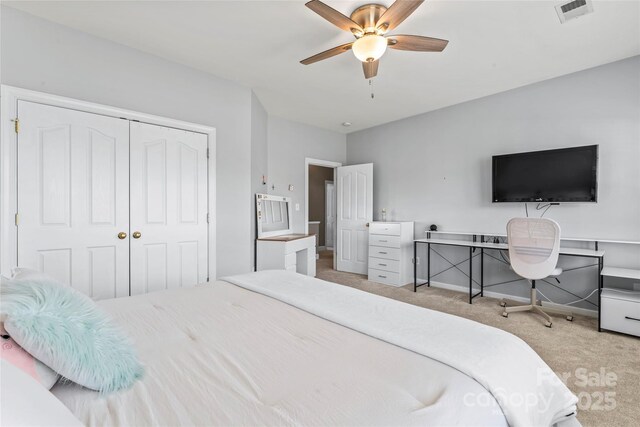 bedroom featuring carpet floors, a closet, ceiling fan, and baseboards