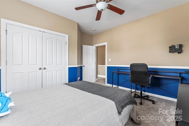 bedroom with carpet, a closet, a ceiling fan, an office area, and baseboards