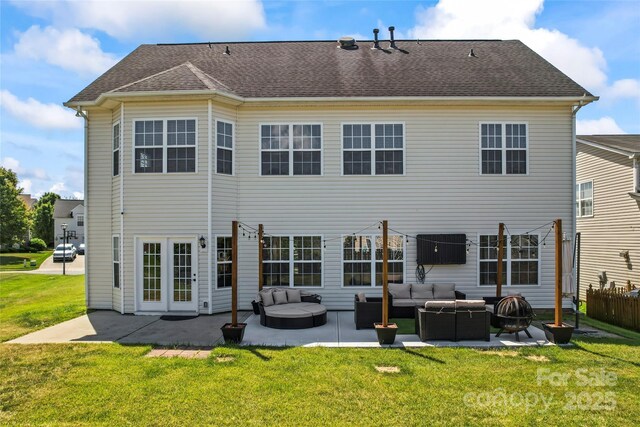 back of house featuring outdoor lounge area, a patio area, a yard, and a shingled roof