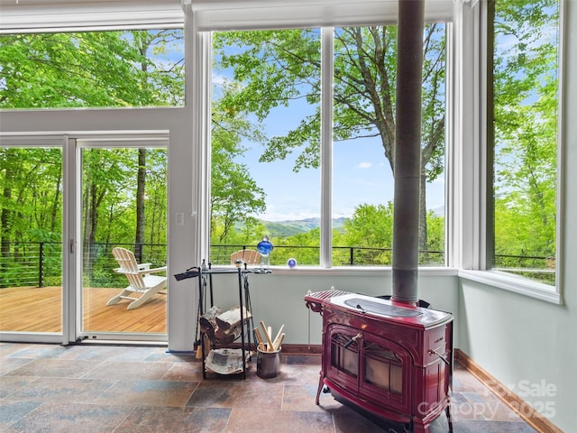 319 Twilight Way, Burnsville, NC 28714 - sunroom / solarium featuring a wood stove and a mountain view