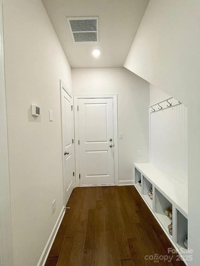 mudroom with dark wood-type flooring and baseboards