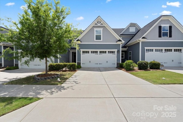 craftsman house featuring board and batten siding, concrete driveway, and stone siding