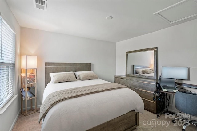 carpeted bedroom with baseboards and attic access