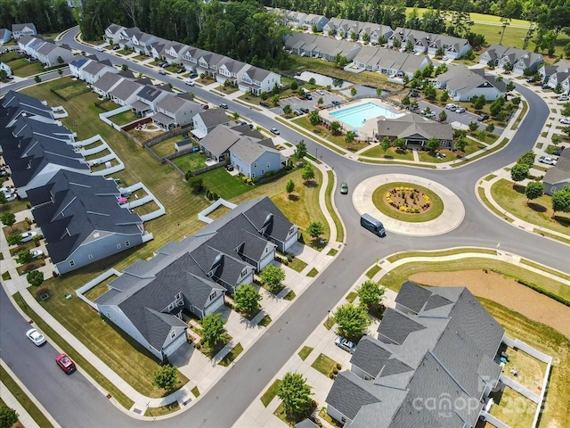 view of property location with a pool and nearby suburban area