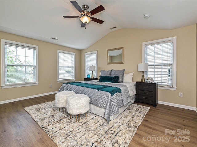 bedroom featuring dark wood-type flooring, baseboards, lofted ceiling, and a ceiling fan