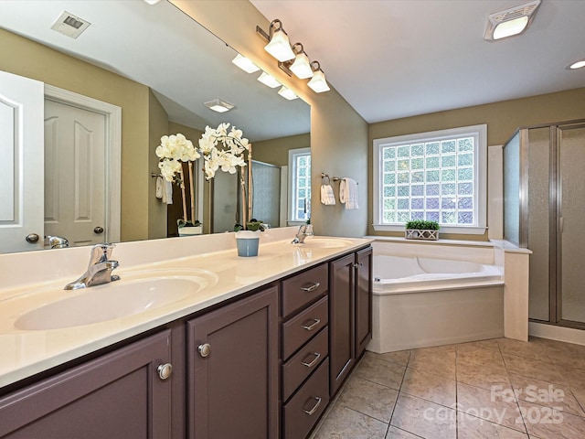 bathroom with a shower stall, double vanity, a bath, and tile patterned floors
