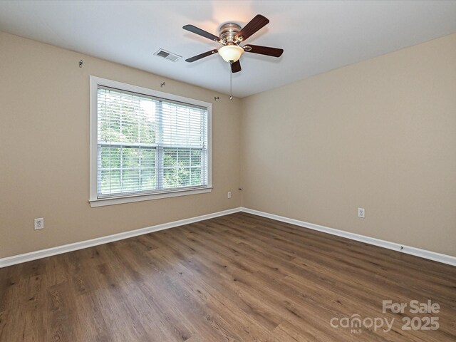 unfurnished room featuring a ceiling fan, baseboards, and wood finished floors