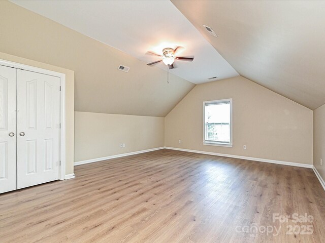 bonus room with wood finished floors, ceiling fan, baseboards, and lofted ceiling