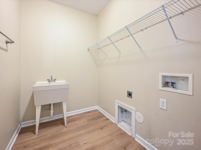 laundry room with washer hookup, electric dryer hookup, baseboards, and wood finished floors
