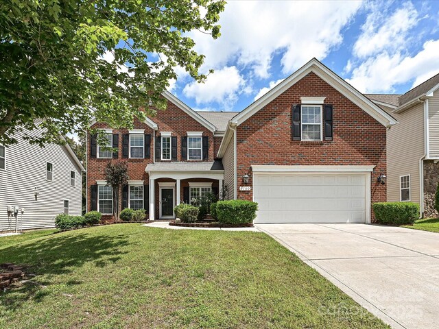 view of front facade featuring brick siding, an attached garage, concrete driveway, and a front lawn