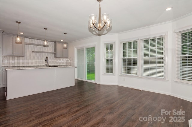 104 Gallarie Pl, Salisbury, NC 28144 - kitchen with gray cabinetry, backsplash, a center island with sink, dark wood-style flooring, and a chandelier