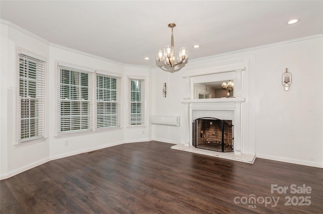 104 Gallarie Pl, Salisbury, NC 28144 - unfurnished living room with a chandelier, ornamental molding, wood finished floors, a fireplace with raised hearth, and recessed lighting