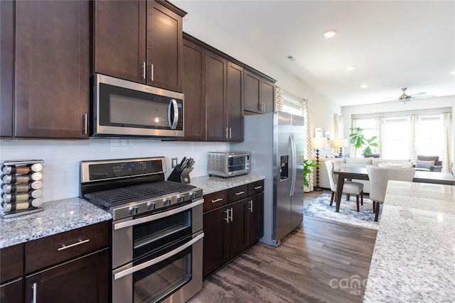 9521 Ainslie Downs St, Charlotte, NC 28273 - kitchen with appliances with stainless steel finishes, dark brown cabinetry, dark wood-style floors, recessed lighting, and open floor plan