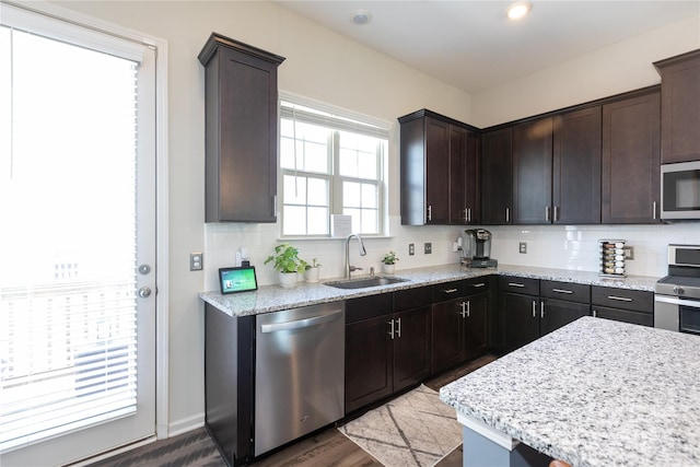 9521 Ainslie Downs St, Charlotte, NC 28273 - kitchen featuring stainless steel appliances, a sink, tasteful backsplash, and dark brown cabinets