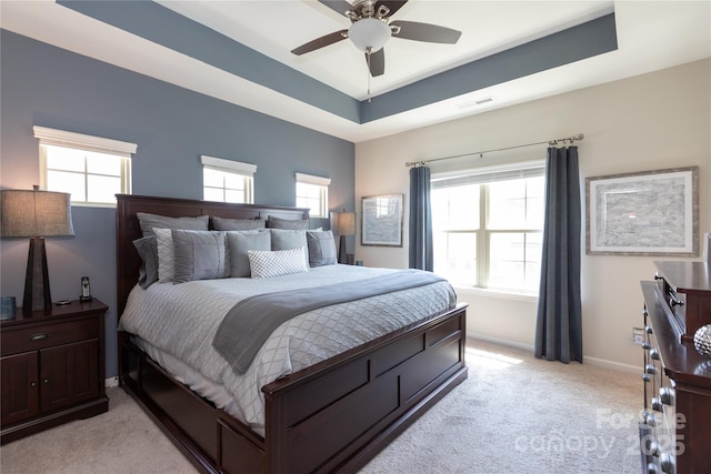 9521 Ainslie Downs St, Charlotte, NC 28273 - bedroom featuring light carpet, baseboards, a tray ceiling, and ceiling fan