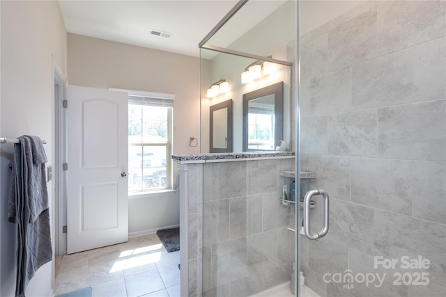 9521 Ainslie Downs St, Charlotte, NC 28273 - bathroom featuring plenty of natural light, a shower stall, and tile patterned floors