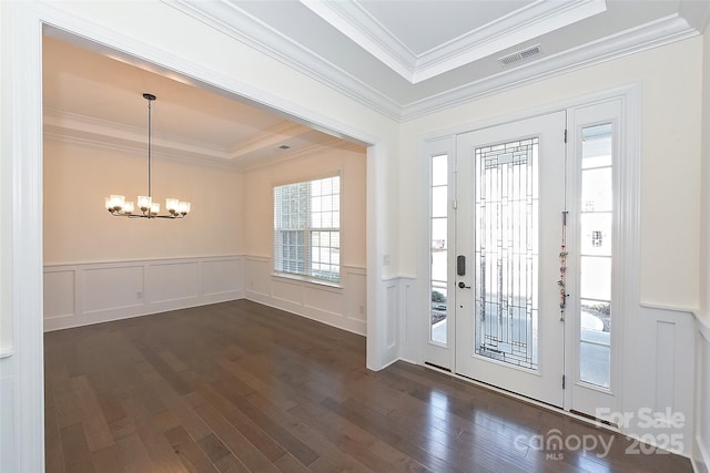 809 Brown Creek Dr, Matthews, NC 28104 - entryway with a chandelier, a tray ceiling, dark wood-type flooring, crown molding, and a decorative wall