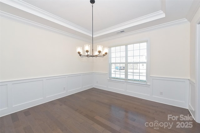 809 Brown Creek Dr, Matthews, NC 28104 - unfurnished dining area with a chandelier, ornamental molding, dark wood finished floors, a wainscoted wall, and a raised ceiling