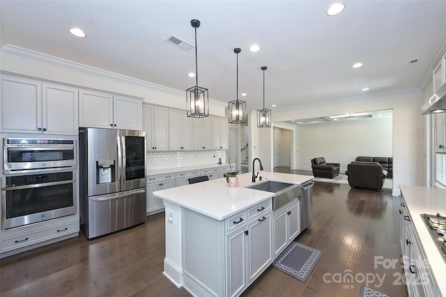809 Brown Creek Dr, Matthews, NC 28104 - kitchen featuring stainless steel appliances, a sink, crown molding, open floor plan, and recessed lighting