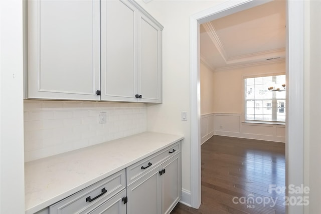 809 Brown Creek Dr, Matthews, NC 28104 - bar with crown molding, dark wood finished floors, decorative backsplash, a wainscoted wall, and a tray ceiling