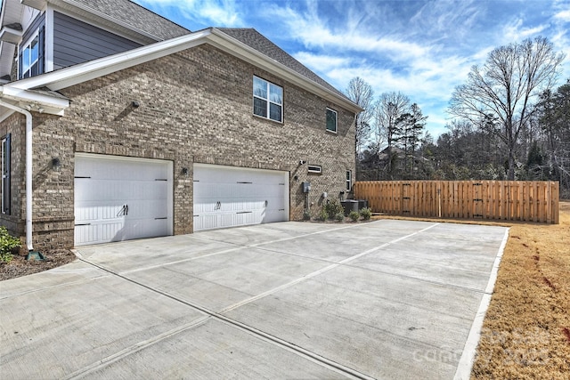 809 Brown Creek Dr, Matthews, NC 28104 - view of side of property featuring concrete driveway, fence, brick siding, and central air condition unit
