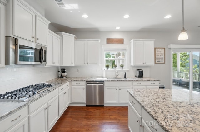 16831 Alydar Commons Ln, Charlotte, NC 28278 - kitchen with stainless steel appliances, healthy amount of natural light, white cabinets, tasteful backsplash, and recessed lighting