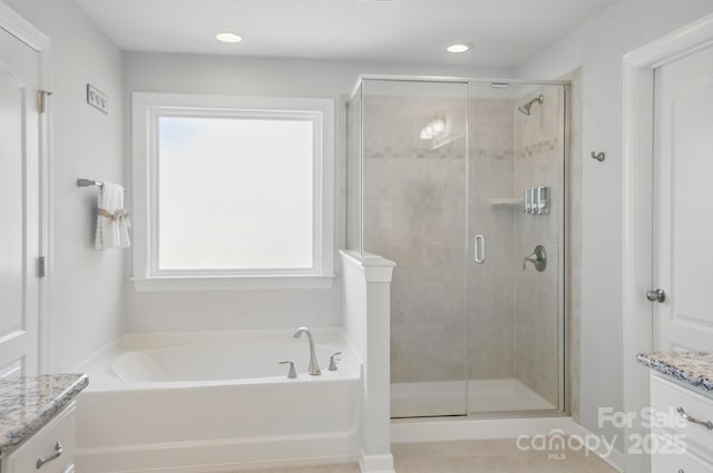 16831 Alydar Commons Ln, Charlotte, NC 28278 - bathroom featuring vanity, a garden tub, a shower stall, and recessed lighting