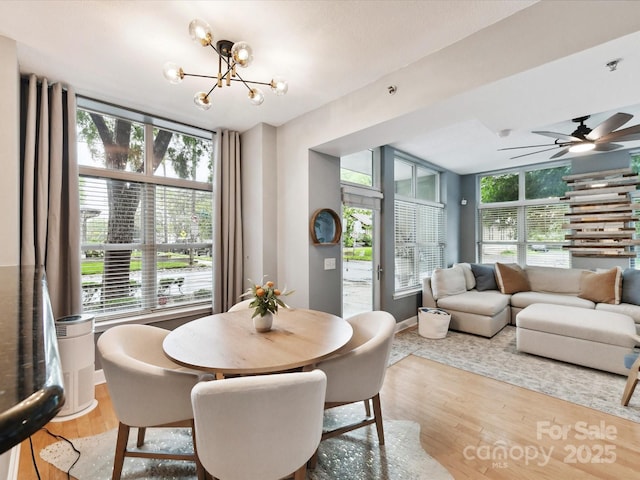 dining area with a chandelier and wood finished floors