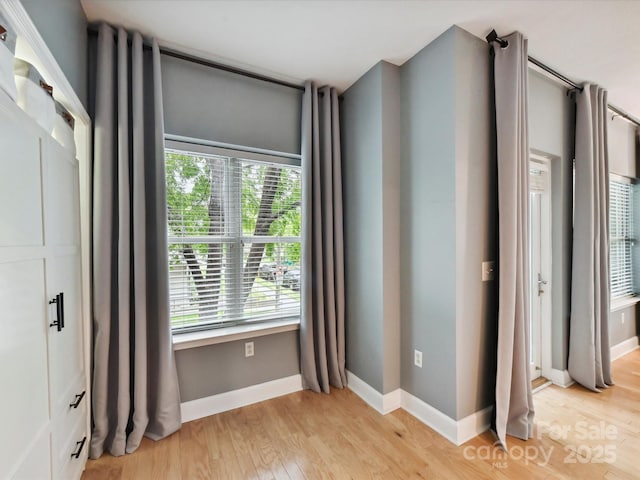 unfurnished bedroom with light wood finished floors and baseboards