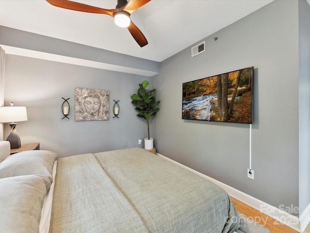 bedroom with wood finished floors, ceiling fan, and baseboards