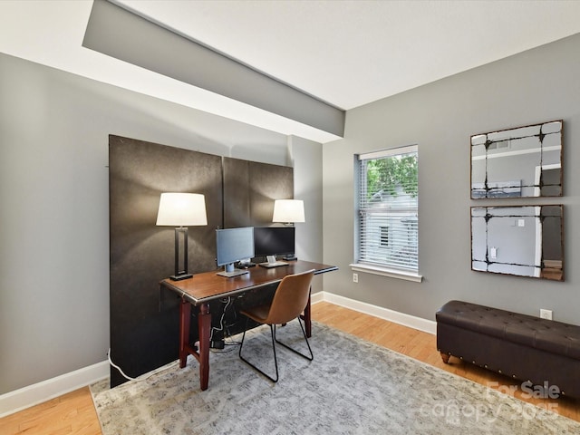 office featuring baseboards and wood finished floors