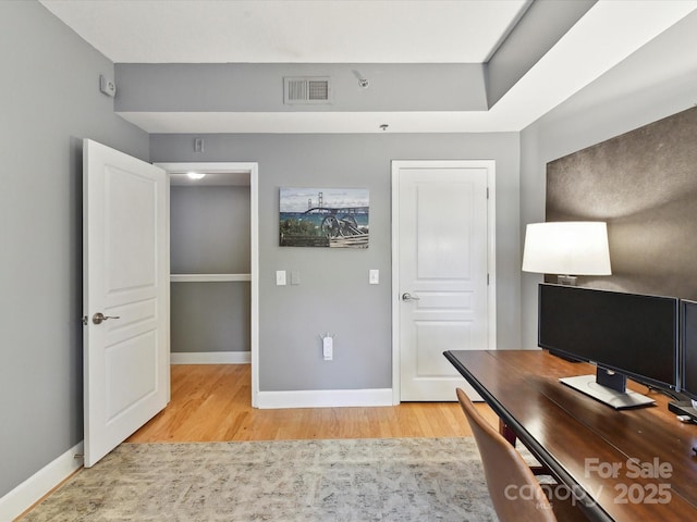 office area with light wood finished floors and baseboards
