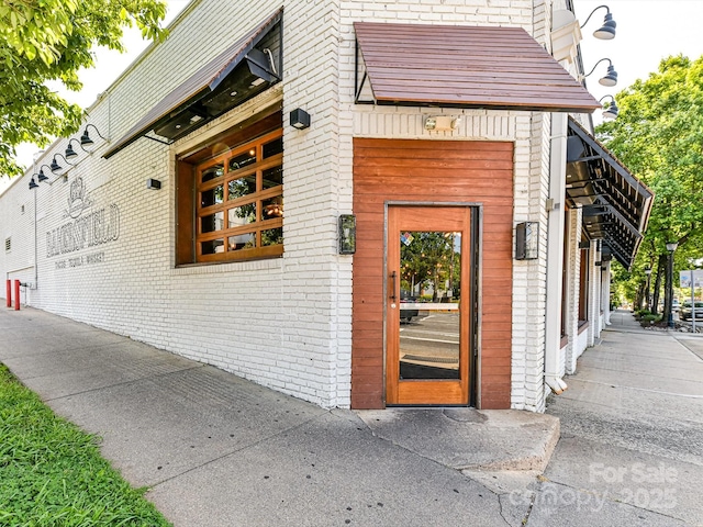 entrance to property with brick siding
