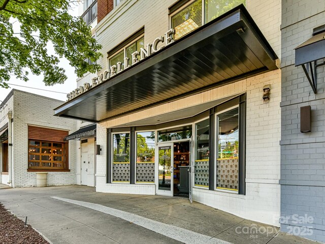 view of exterior entry with brick siding