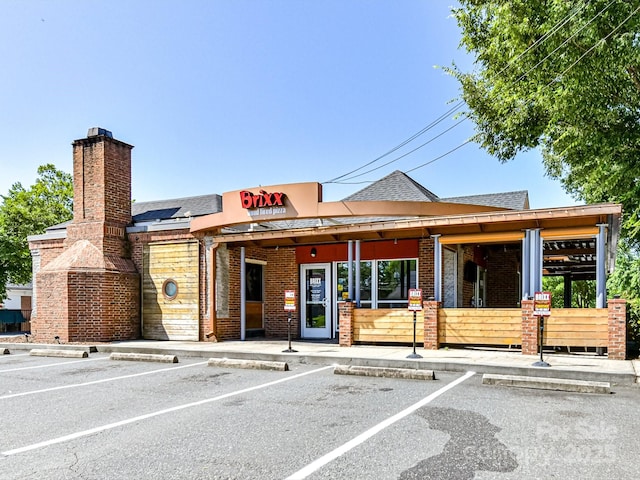 view of building exterior with uncovered parking