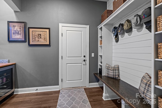 mudroom with dark wood-type flooring and baseboards