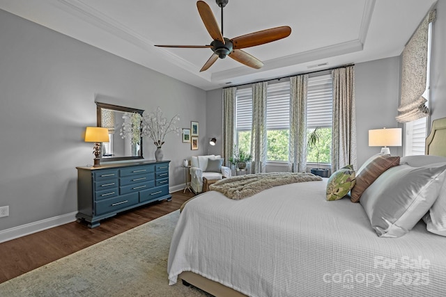 bedroom featuring a tray ceiling, baseboards, dark wood-style flooring, and ceiling fan