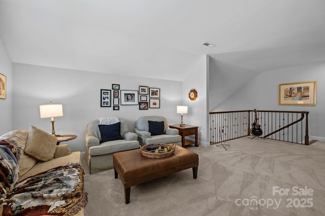 carpeted living room featuring lofted ceiling and baseboards