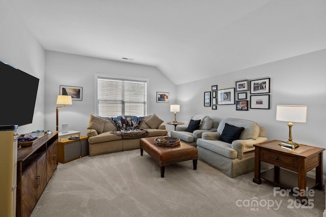 living area featuring lofted ceiling and light carpet