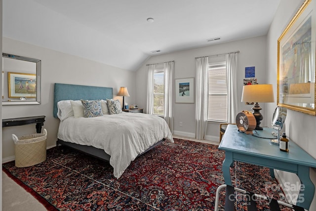 bedroom with carpet flooring, lofted ceiling, and baseboards