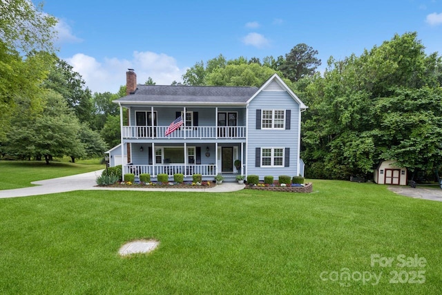 16612 Grapperhall Dr, Huntersville, NC 28078 - view of front facade with covered porch, a chimney, a storage shed, an outbuilding, and a front yard